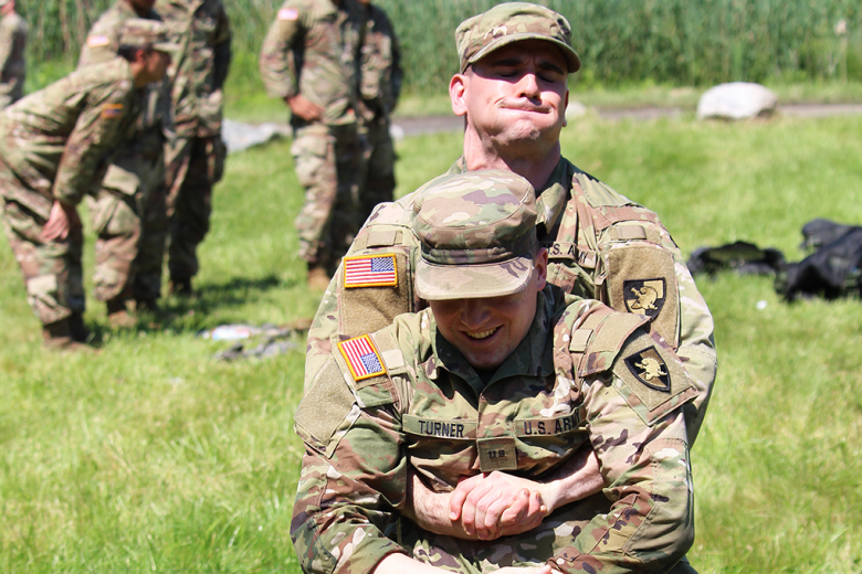 Cadets from Cadet Field Training’s 6th Company completed Combat Lifesaver recertification under the instruction of medics from Task Force Catamount from the 10th Mountain Division. This training involved the application of tourniquets, the administration of a needle-chest decompression (above), and the completion of tactical combat casualty care cards. They also received training on casualty movement techniques (below) and heat casualty prevention.  (Photo by Class of 2022 Cadet Caleb Gordon)