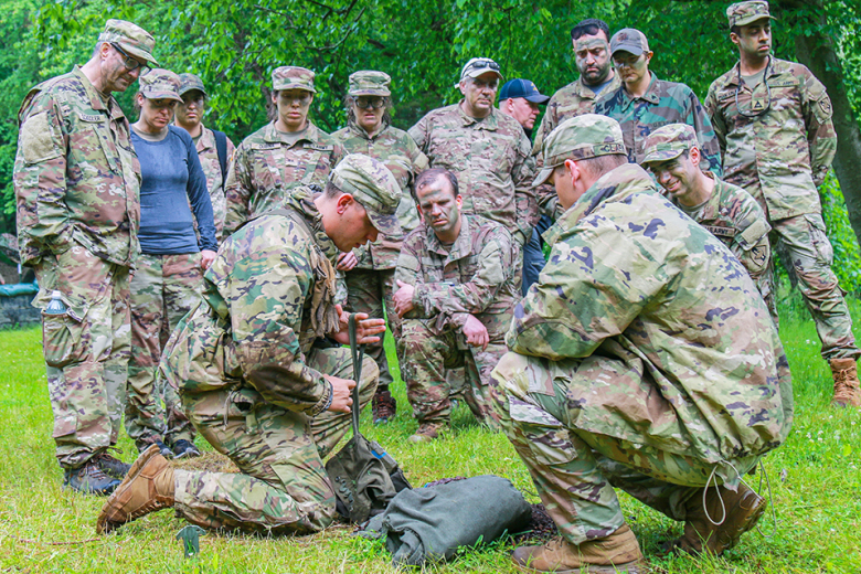 Civilian instructors at the U.S. Military Academy learn how to properly stage a claymore mine during the Civilian-Military Experience June 2 at Camp Buckner. 