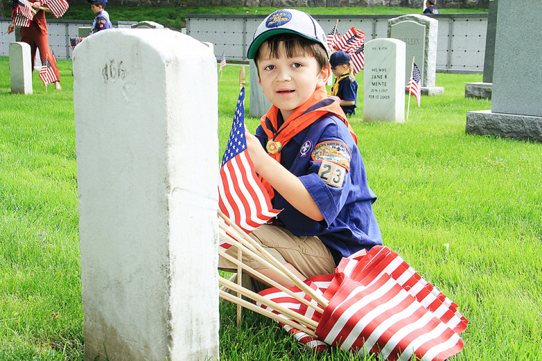 Members of the Boy Scouts of America and Girl Scouts of America planted flags at each headstone in the West Point Cemetery May 26 to honor those who served and those who died in service to the United States. The honor was done prior to Memorial Day, which honors service members who made the ultimate sacrifice to the nation.  												                                  Photos by Jorge Garcia/PV