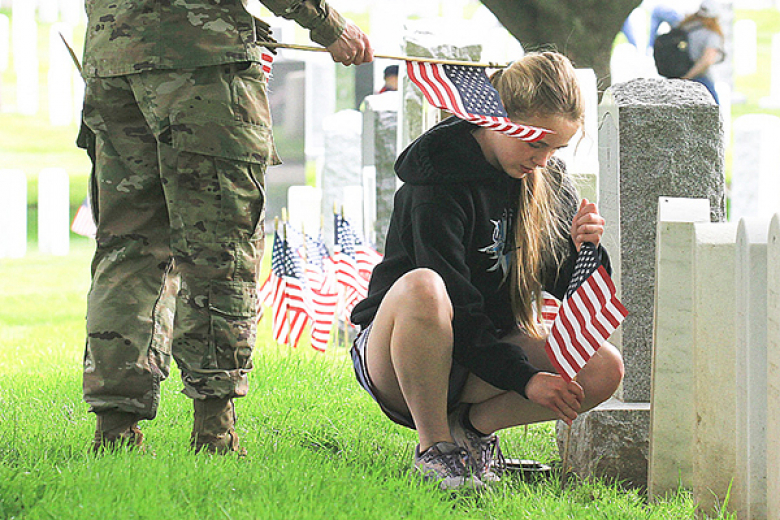 Members of the Boy Scouts of America and Girl Scouts of America planted flags at each headstone in the West Point Cemetery May 26 to honor those who served and those who died in service to the United States. The honor was done prior to Memorial Day, which honors service members who made the ultimate sacrifice to the nation.  												                                  Photos by Jorge Garcia/PV