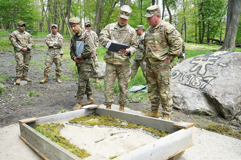 First Lt. Kyle Wilson (left), range officer-in-charge for the team live-fire lane with Task Force Leader, provides a brief to Col. Alan Boyer, Department of Military Instruction director, on team live-fire training, during the task force's training validation by DMI May 17 at Range 17. 