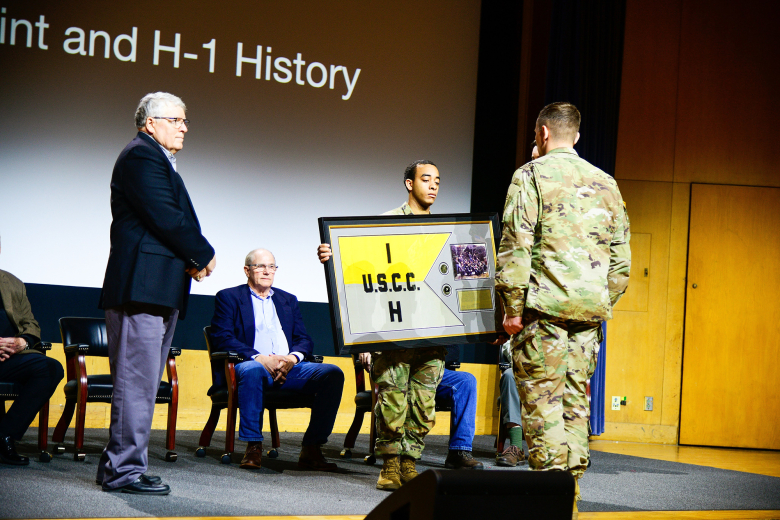 After nearly 50 years, the original Company H-1 guidon was returned to Company H-1 during a ceremony on March 25 at Robinson Auditorium in Thayer Hall. U.S. Naval Academy Midshipmen stole the H-1 guidon and other companies’ guidons during the 1974 Army-Navy Game. While other guidons were later returned, the H-1 guidon remained lost in possession of Midshipmen for 50 years. Former Company H-1 members regained possession of the original guidon by exchanging it for a Company H-1 challenge coin.