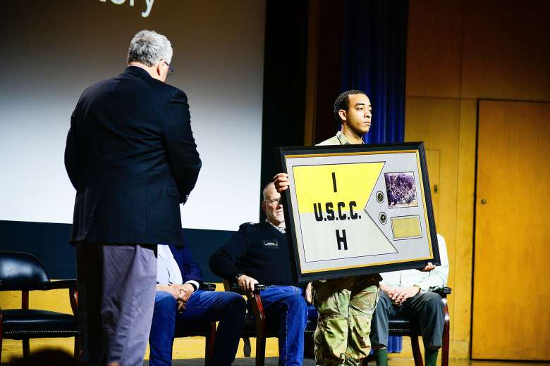 After nearly 50 years, the original Company H-1 guidon was returned to Company H-1 during a ceremony on March 25 at Robinson Auditorium in Thayer Hall. U.S. Naval Academy Midshipmen stole the H-1 guidon and other companies’ guidons during the 1974 Army-Navy Game. While other guidons were later returned, the H-1 guidon remained lost in possession of Midshipmen for 50 years. Former Company H-1 members regained possession of the original guidon by exchanging it for a Company H-1 challenge coin.