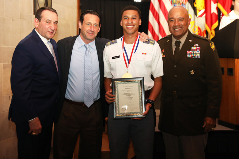 Mike Krzyzewski (center) stands with the awardees of the 16th annual Coach Mike Krzyzewski Teaching Character Through Sport Awards May 5 in the Arvin Cadet Physical Development Center. From left to right: Dr. Drew VanDam (Company Athletics Sport Educator/Ultimate Frisbee), Col. Michael Benson (Competitive Club Athletics/Water Polo), Class of 2022 Cadet James Irish (Company Athletics/Basketball), Class of 2022 Cadet Mitch Gilley (Competitive Club Athletics/Climbing), Class of 2022 Cadet Aaron Duhart