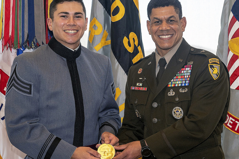 Class of 2022 Cadets Mennat-Allah T. Mohamed (right) and Carter J. Macias (left) receive their medals from the Commandant of Cadets, Brig. Gen. Mark Quander, during the 10th annual Lt. Gen. Hal Moore Warrior Athlete of Excellence Award Nov. 10 in the Haig Room, Jefferson Hall.    Photos by Christopher Hennen/USMA PAO	