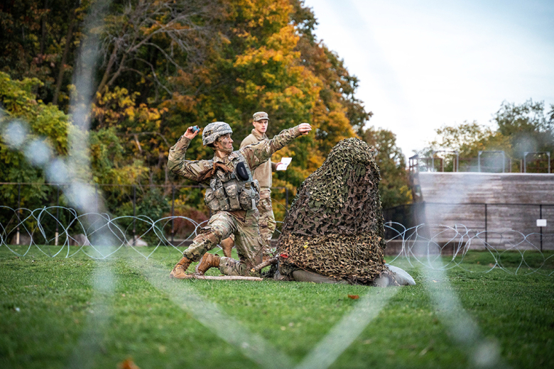 A cadet from the U.S. Military Academy tosses a dummy grenade on a grenade assault course.