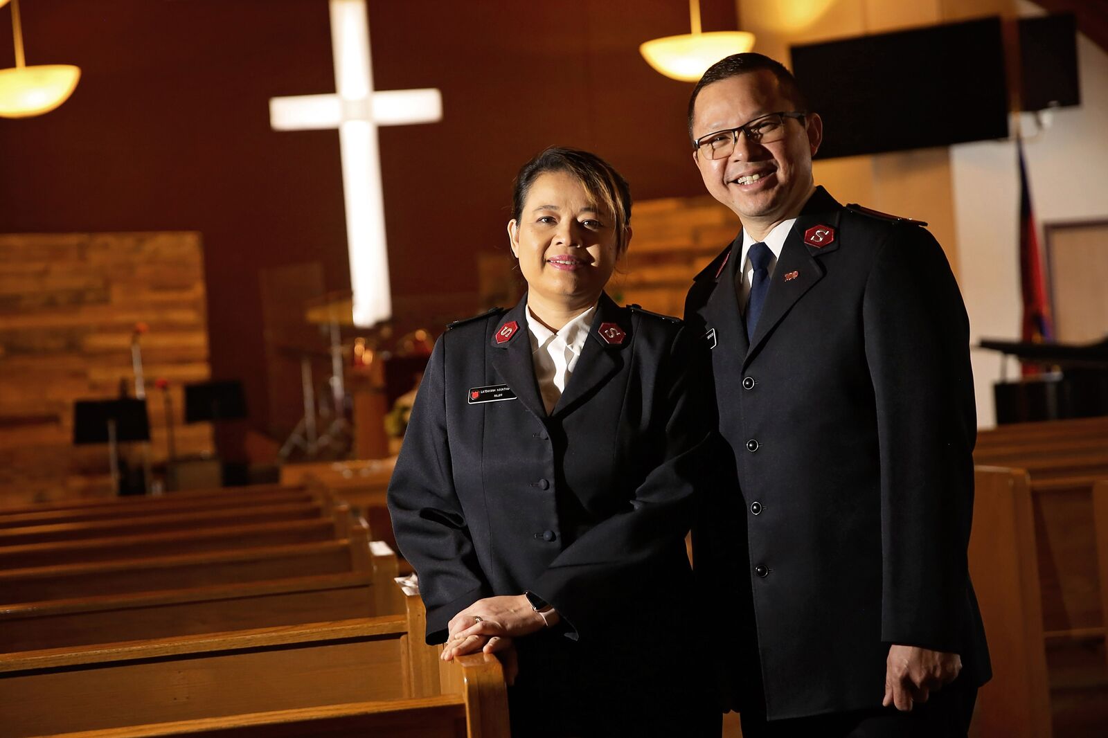 Two Salvation Army officers in uniform, smiling.