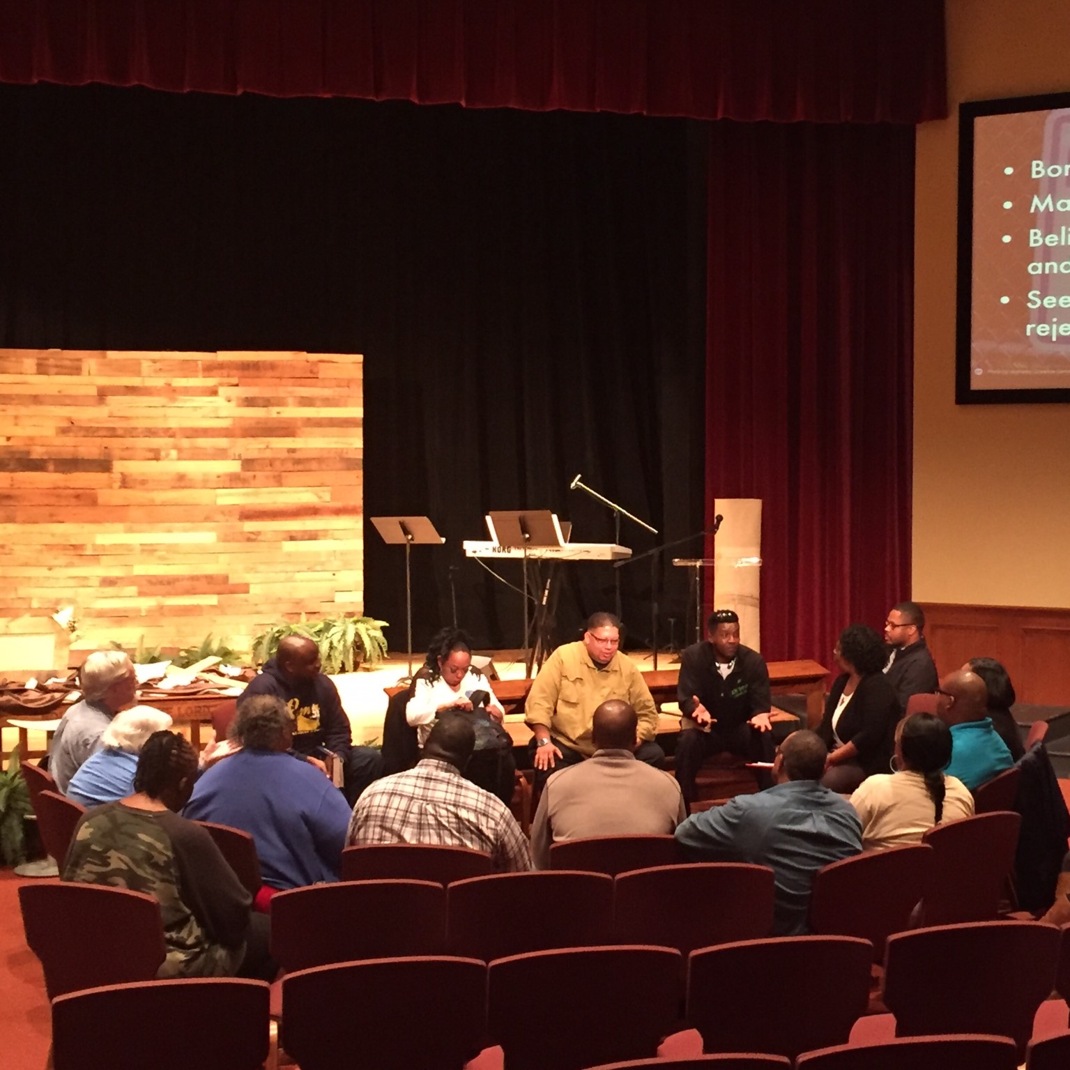 Church members sitting together discussing the Bible.