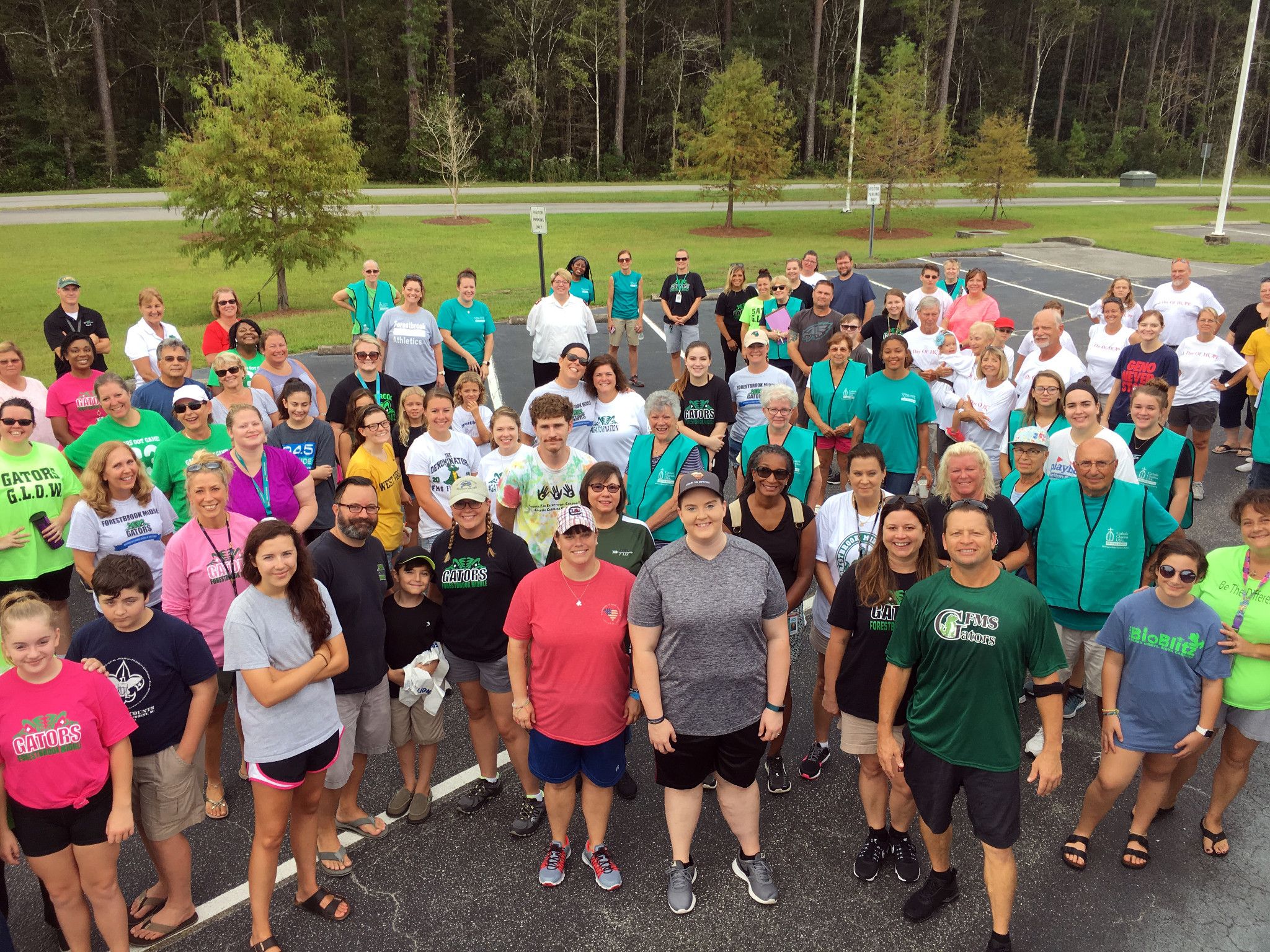 A large group of Salvation Army volunteers gathered outdoors in matching shirts.