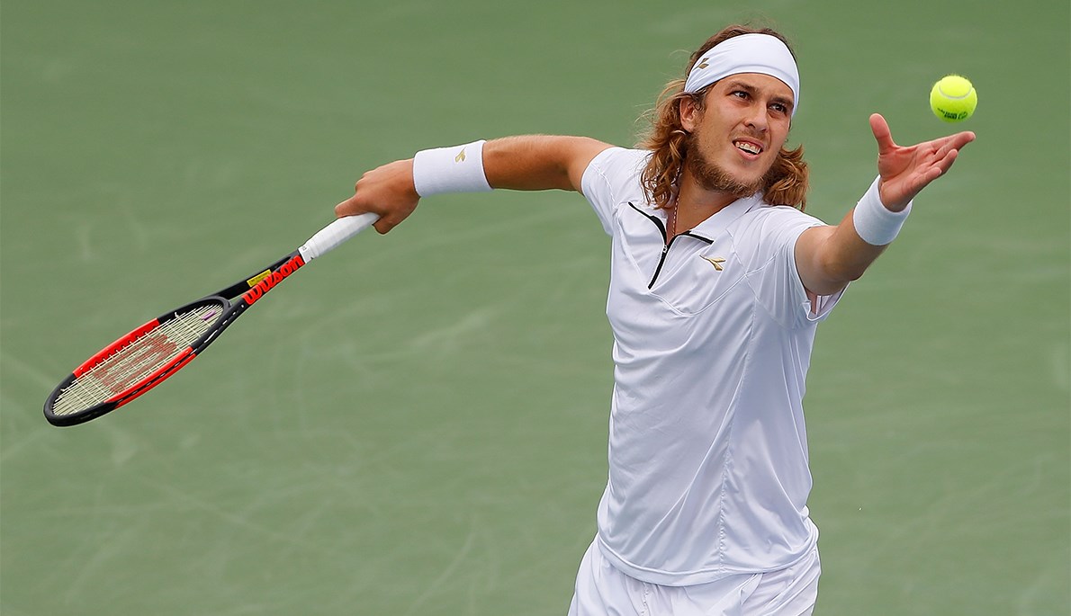 Lukas Lacko serves to John Isner during their quarterfinal tilt. 