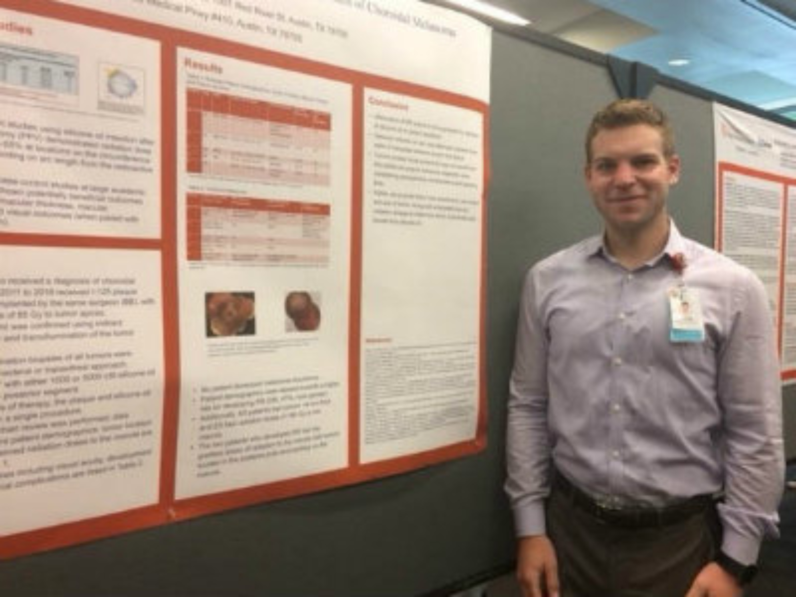 Male resident presenting a research poster.
