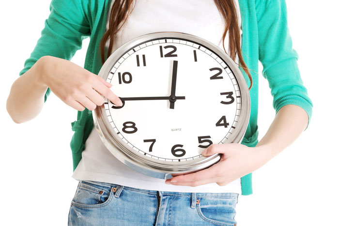 Student holding clock