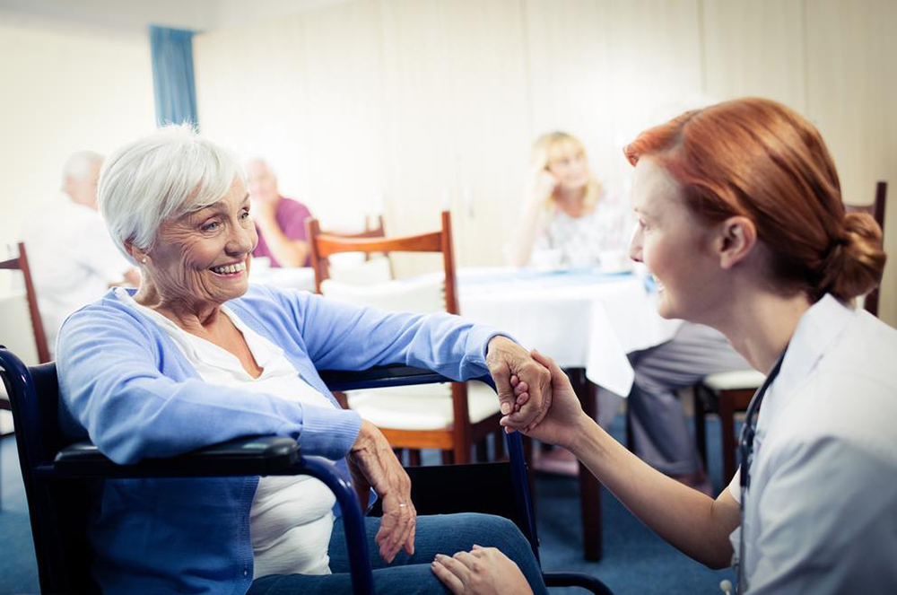 Nurse with elderly nursing home resident