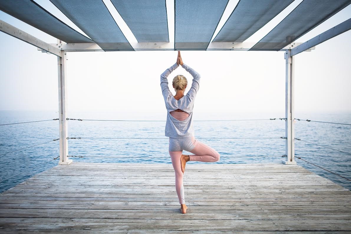 Woman practices yoga. Exercise is an important component of preventative health.