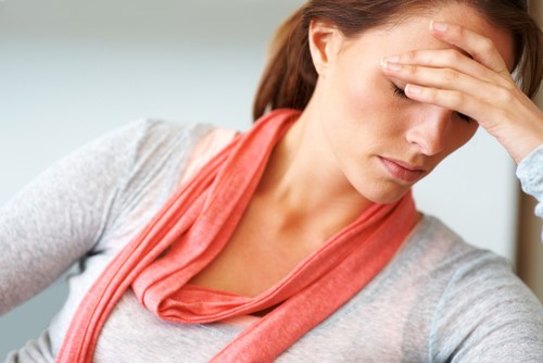Woman holding her head in frustration.