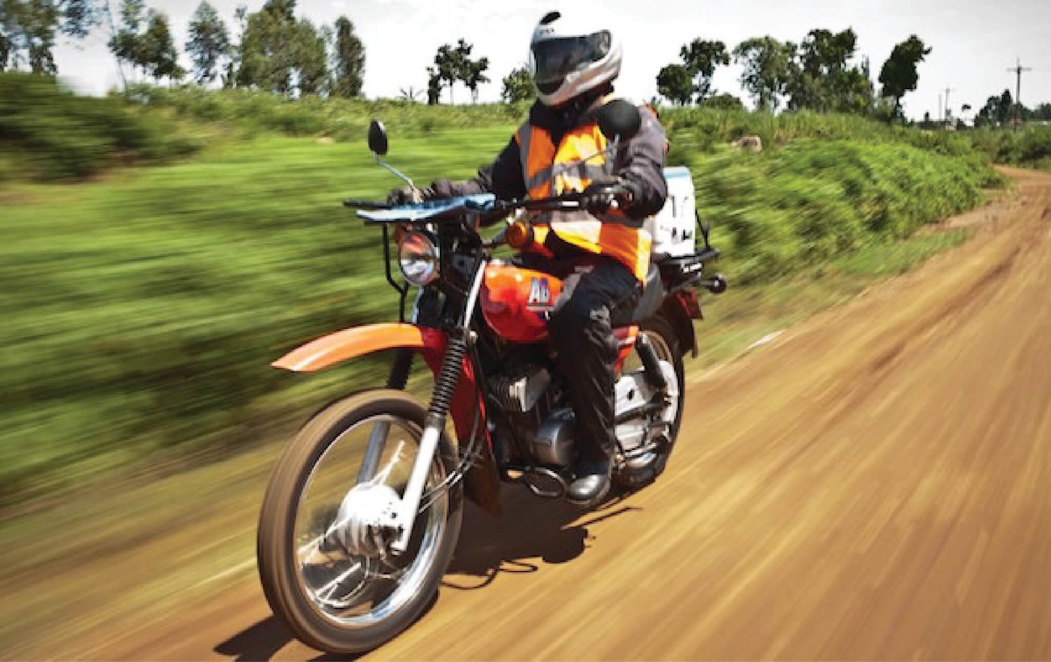 Riders for Health member on a motorcycle.