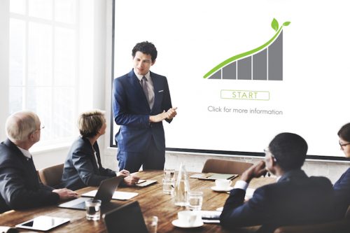 A businessman speaking at a meeting.