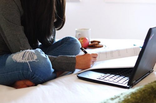 A student reviewing course materials at home.