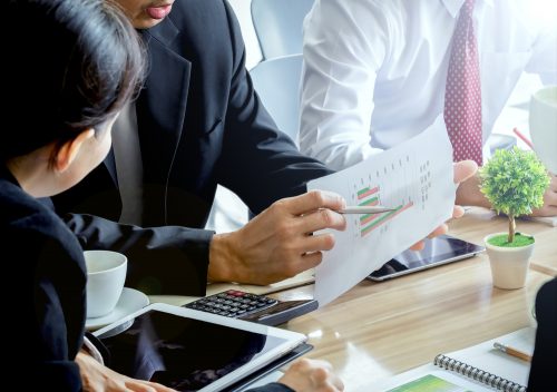 Supply chain managers holding a discussion at a table.