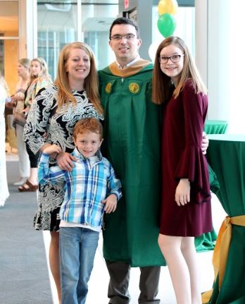 Online MAc Graduate with his wife and two kids