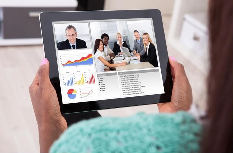 Businesswoman uses UC solutions to attend a remote meeting