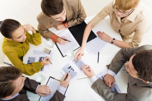 A group of colleagues have a morning scrum meeting