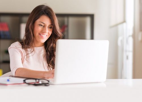 A remote accountant works on a laptop.