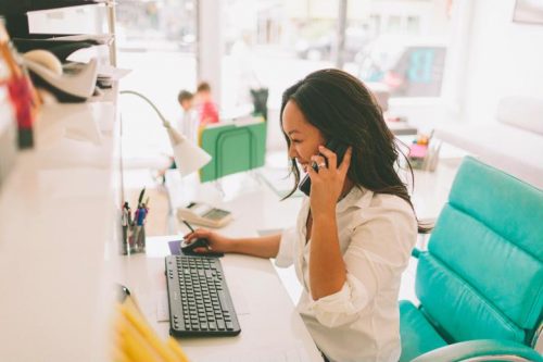 A fundraising manager speaks on the phone with a potential donor.