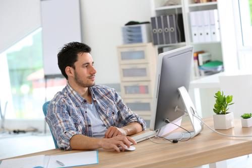 Young MBA professional working on a computer.
