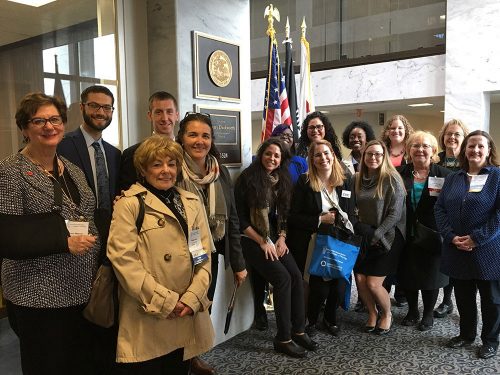 Group of people in front of The American Association of Colleges of Nursing (AACN) Student Policy Summit