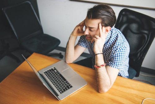 Stressed man at computer