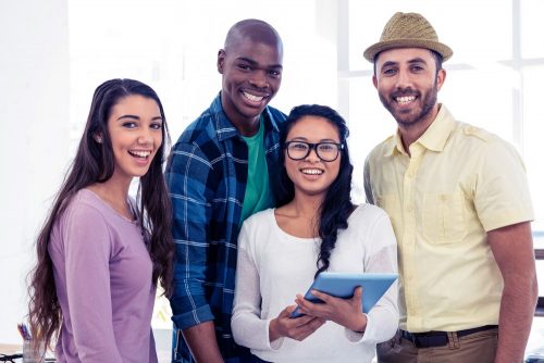 A diverse group of male and female students smiling at the camera
