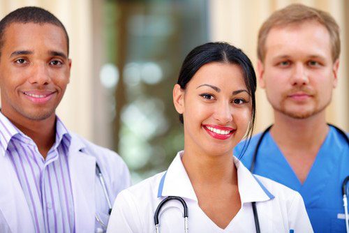 A variety of medical professionals pose for a photo.