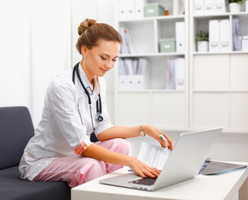 A nurse studies online.
