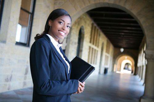 Female Counseling Student Holding A Notebook Smiling at the Camera