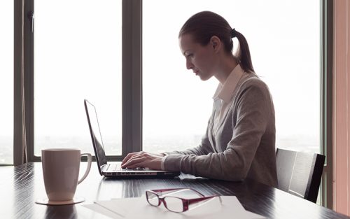 Female medical professional working on laptop