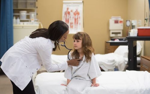African American female doctor with young girl