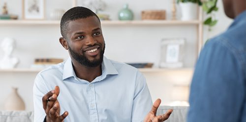 Young black male counselor works with patient