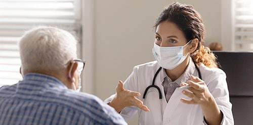 Young female doctor consults with elderly male patient