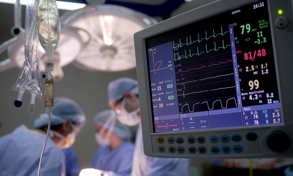 Vital sign monitor displaying next to healthcare workers