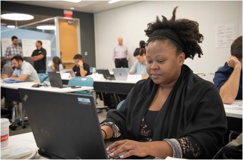 Student in the classroom for an on-campus residency course