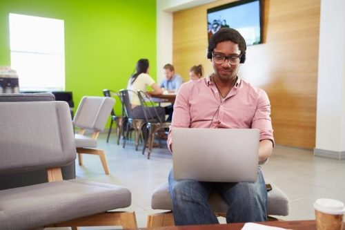 A working professional attends an online MST class by logging on through his laptop.