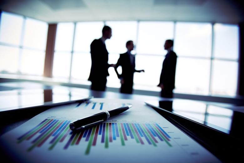 Investment bankers chatting in an office