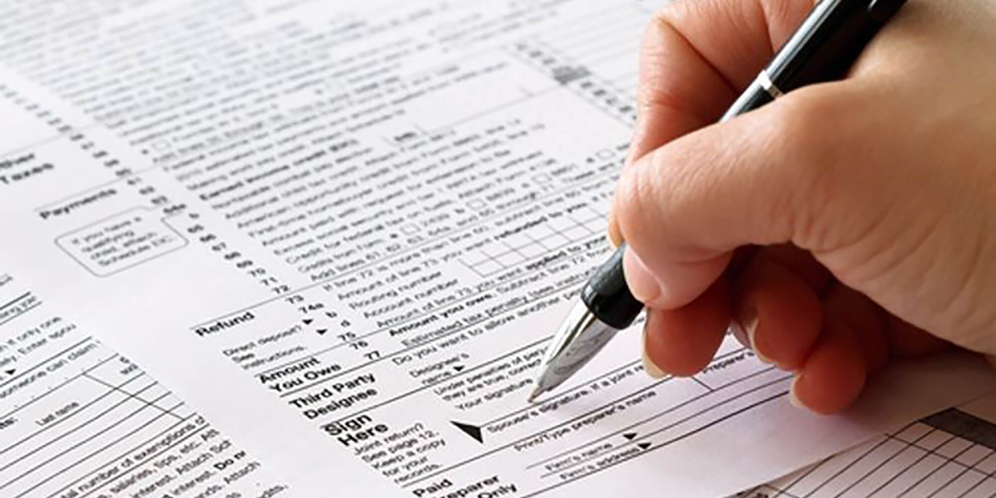 Person filling out an IRS tax form