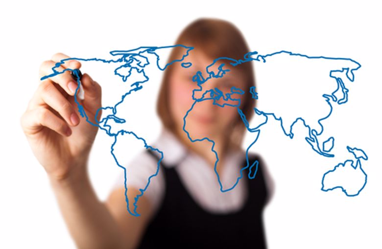 A businesswoman draws a map of the world.