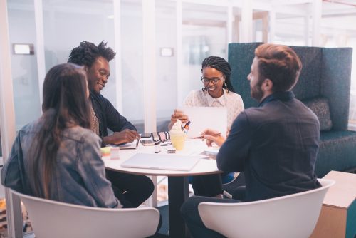 Four people gather for a collaborative meeting.