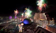 Fireworks over tall buildings at night