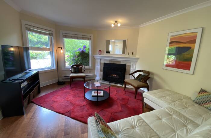 Living Room with gas fireplace, Smart TV and view of the garden