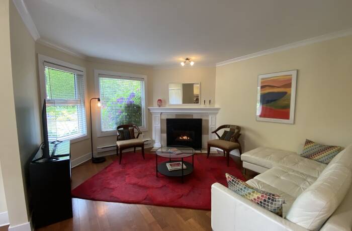 Living Room with gas fireplace, Smart TV and view of the garden
