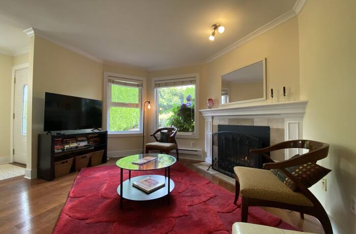 Living Room with gas fireplace, Smart TV and view of the garden